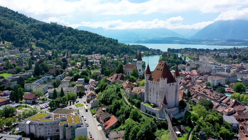Panorama of Thun city with Alps and Thunersee lake, Switzerland. Historical Thun city and lake Thun with Bernese Highlands swiss Alps mountains in background, Canton Bern, Switzerland.