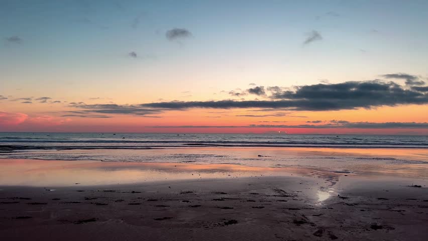 Horseback riding on the beach in Morocco. A man galloping at sunset
