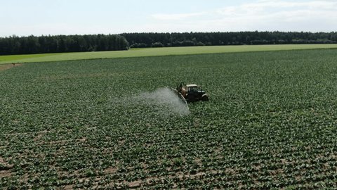 Drone Following Tractor Spraying Crops on Agricultural