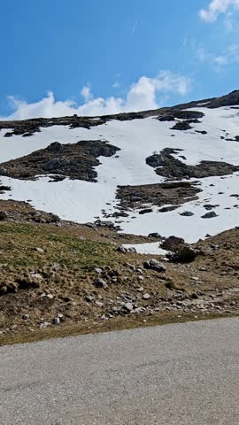 Snowy Mountain Road Along Cliff with Winter Landscape Driving View