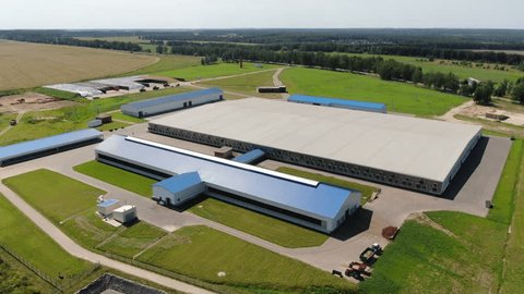 Drone Ascending above Large Agricultural Farm Complex