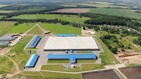 Drone Advancing over Farm Complex Tilt Down