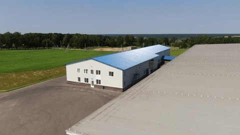 Drone Flying Forward above Roofs Farm Complex
