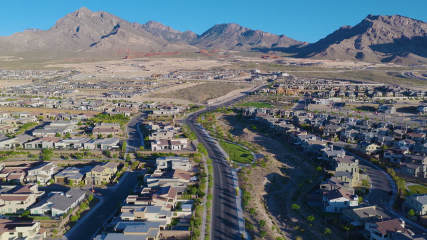 Modern Desert Suburb With Green Parks Below Las Vegas Mountains