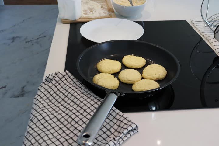 Stop motion video of cooking syrniki in home kitchen. Cottage cheese pancakes frying in pan and moving to plate. Traditional Slavic food preparation, homemade breakfast and simple cooking process. Ind