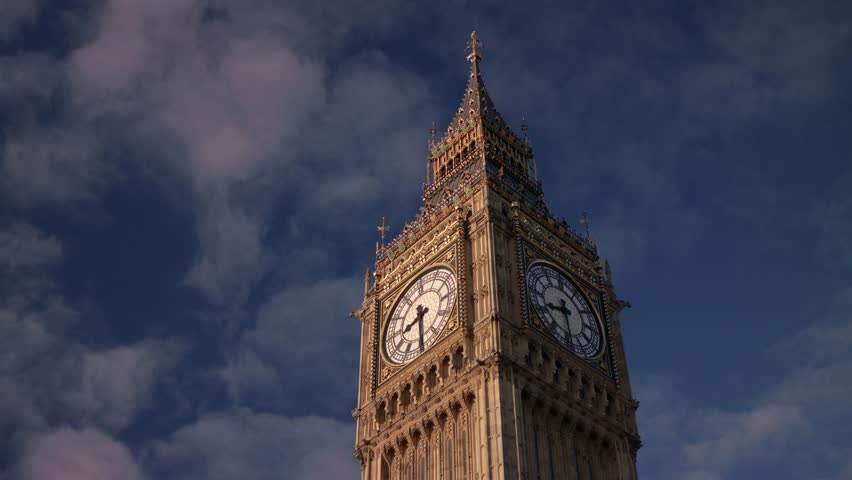 This 4K video shows the Elizabeth Tower at the Palace of Westminster in London. The visual documents the 96-meter tall masonry structure, the four clock faces, and the architectural housing for the 13-ton Great Bell. The composition illustrates Gothic Revival design and urban infrastructure, documenting historical engineering and city landmarks for editorial media.