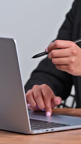 Businesswoman marking a digital checklist holographic icon with a stylus pen
