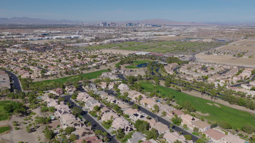 Desert Suburbs And Green Golf Course Below Distant Las Vegas Skyline