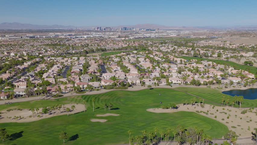 Desert Suburbs and Green Golf Course With Distant Las Vegas Skyline
