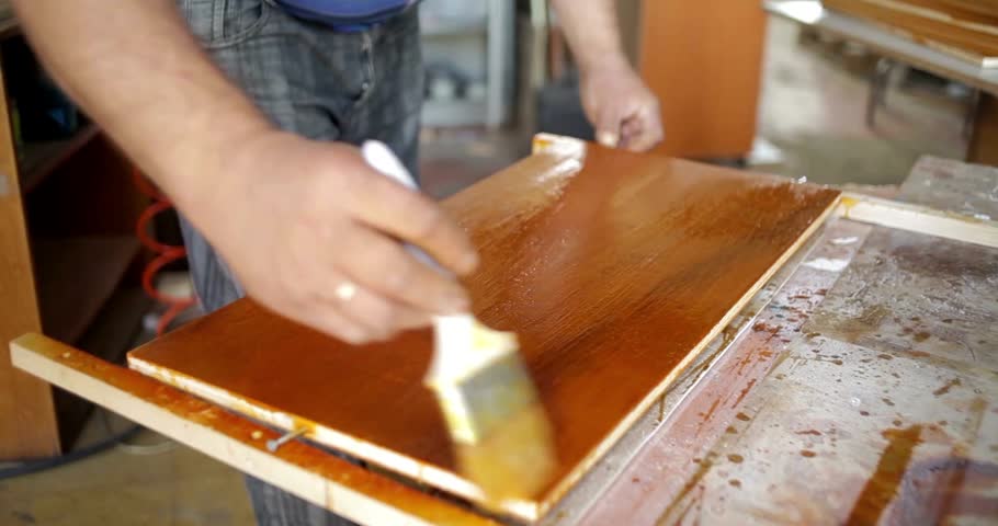 man working with wood Carpenter at work woods workshop Electric saw for sawing boards, worker saws a wooden board