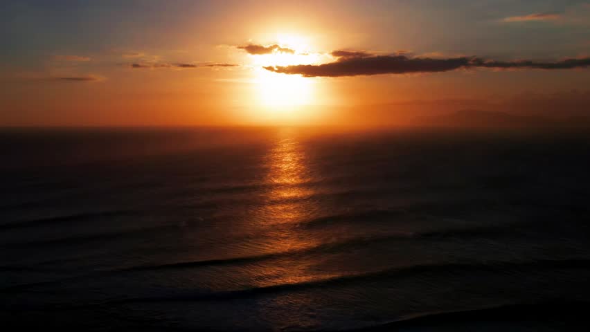 Aerial View Sunset of Golden Sun Reflection Creating Glitter Path on Sea Surface. Spectacular Sunset While Gentle Waves Roll Towards Shore in Peaceful Tropical Paradise at Evening Summer Time 4k