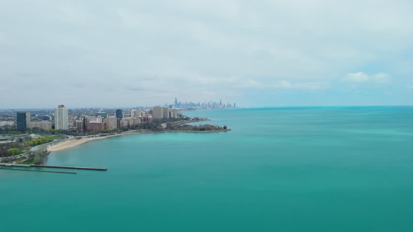 Chicago skyline and Lake Michigan coastline on a cloudy sunny day. Overcast cityscape with downtown skyscrapers and waterfront. Wide view