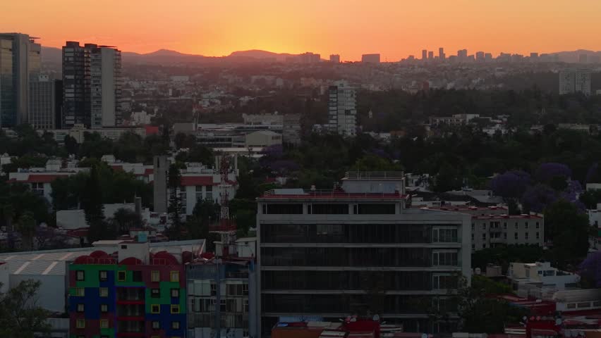 Aerial shot of red sky over dense urban area in CDMX