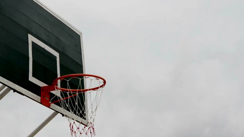 An outdoor basketball hoop at playground. basketball backboard with basket on outdoor playground. Video of basketball net hanging outdoors at park.