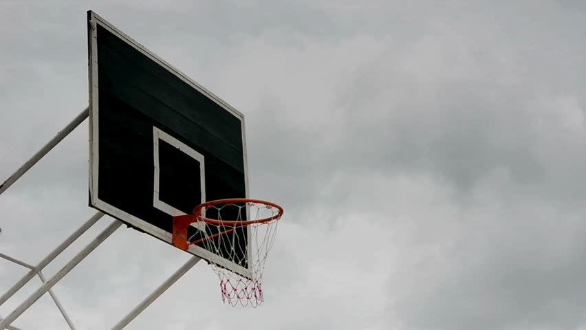 An outdoor basketball hoop at playground. basketball backboard with basket on outdoor playground. Video of basketball net hanging outdoors at park.