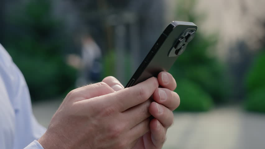 Close up Caucasian business man male hands typing smartphone outside city texting online message middle aged businessman entrepreneur holding mobile phone chatting app use gadget device browsing work