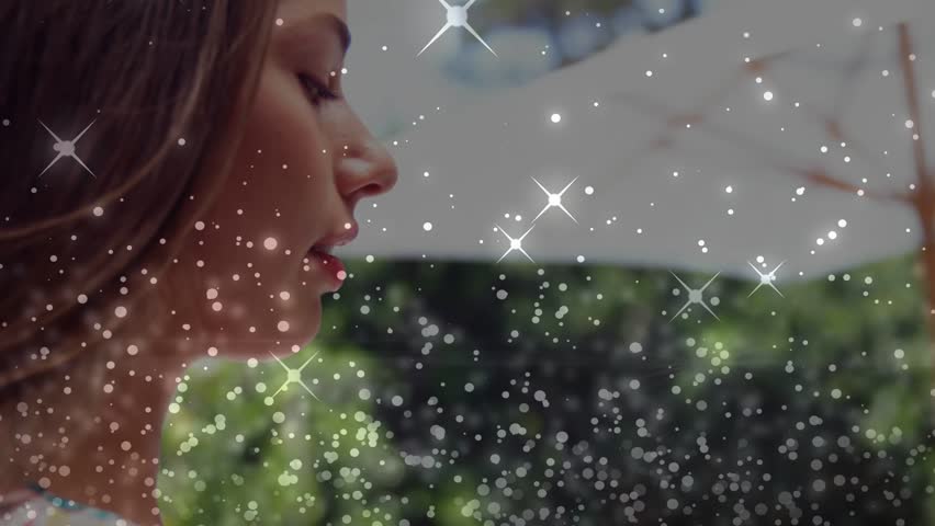 Woman turning left to camera on start, sparkle overlay moving across face, forming marketing clip. Headshot, outdoor, garden, patio, canopy, floral, glow