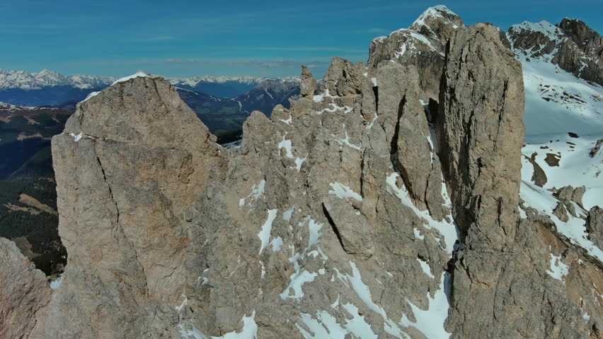 Aerial around view of majestic rocky mountains in snow Alps, Dolomites, Italy, 4k