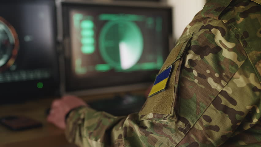 Ukrainian air defense officer gathering satellite data, managing defense systems