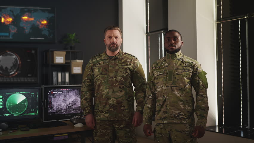 Portrait of two professional army officers standing in military command center