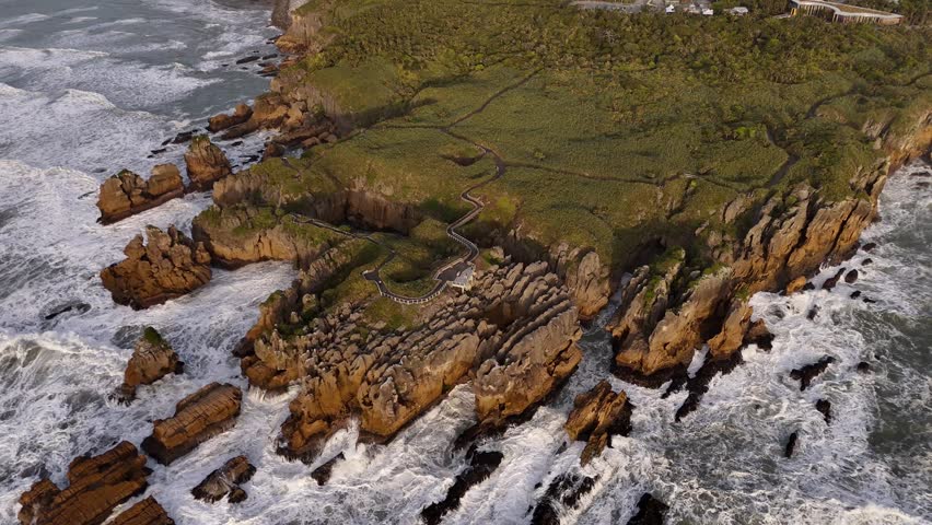 Wide aerial view of Pancake Rocks at sunset Punakaiki New Zealand, aerial drone shot high angle