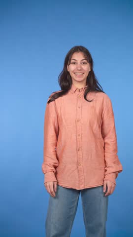 Portrait of a happy and confident young woman smiling at the camera with her arms crossed. Attractive female model posing in a studio
