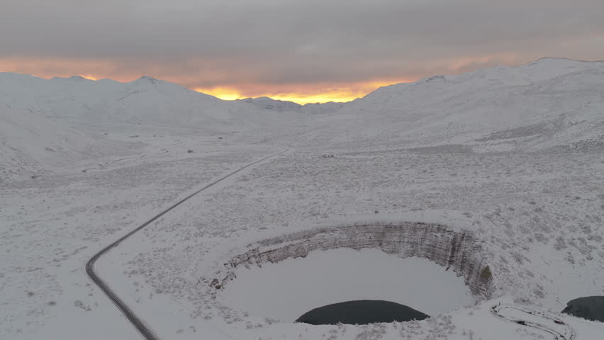 Scenic mountain road Ruta 222 crossing snowy Andes landscape at sunrise near Pozo de las Animas in Mendoza Argentina.
