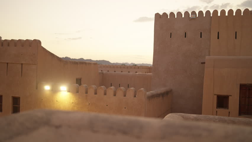 Horizontal static timelapse from the upper battlements of Nizwa Fort. Watching the sun set over the city, the iconic blue-domed mosque, and the lush palm groves at the foot of the mountains.