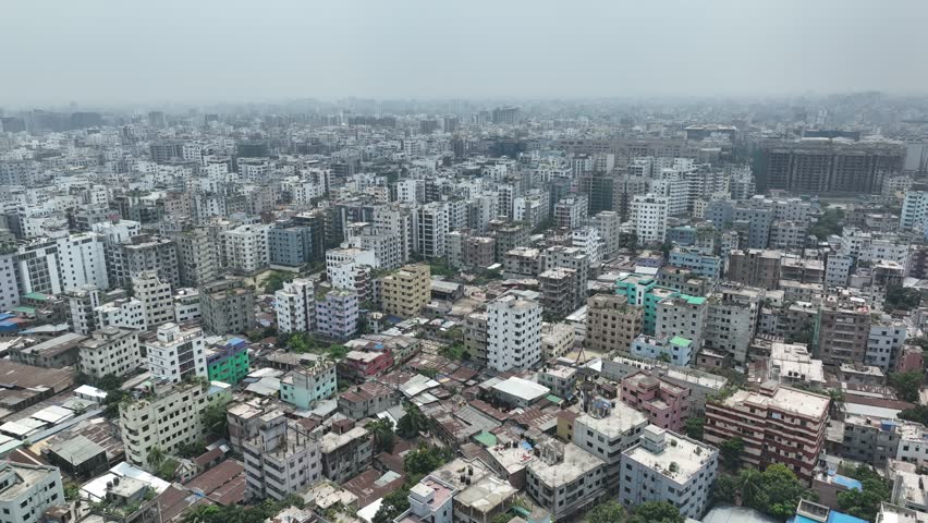 Aerial view of a densely populated urban area featuring countless residential buildings and apartments stretching to the horizon under a hazy sky in dhaka, the capital city of bangladesh