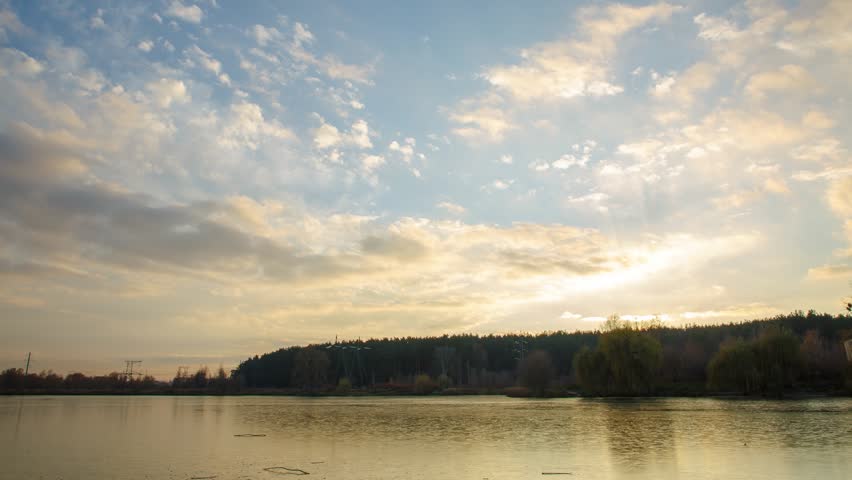 Timelapse with a view of the forest and lake, a beautiful sunset