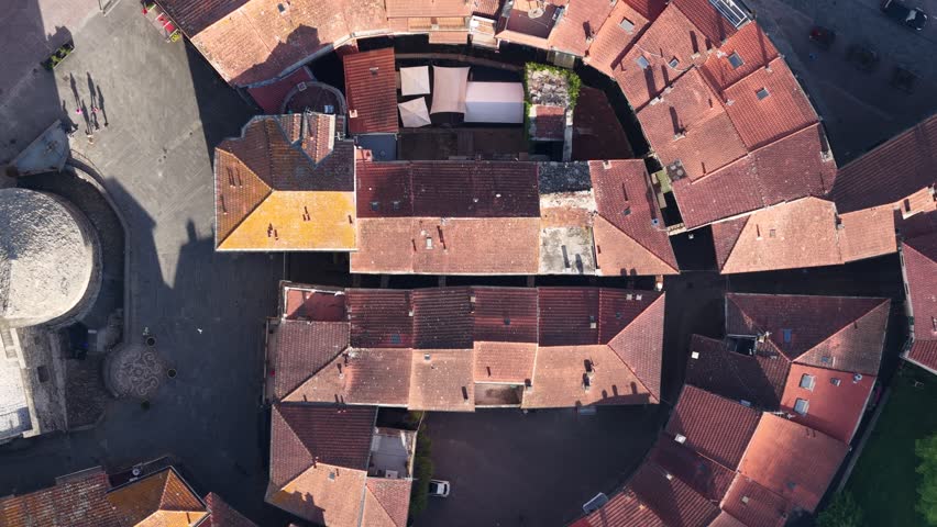 Aerial view of the unique circular Borgo Rotondo with its historic red-tiled rooftops and narrow streets in Varese Ligure, Liguria, Italy.