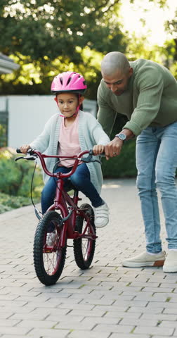 Learning, father and girl with bicycle in backyard, support and guidance for coordination development. Smile, teaching balance and man with child for cycling practice, improve motor skills or bonding