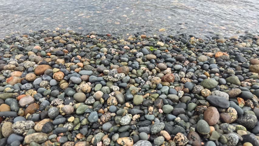 Haines - Alaska - USA - April 21, 2024 - Close up of pebbles smoothly rounded by water, densely covering the shoreline of Chilkat Inlet in Southest Alaska near Haines.