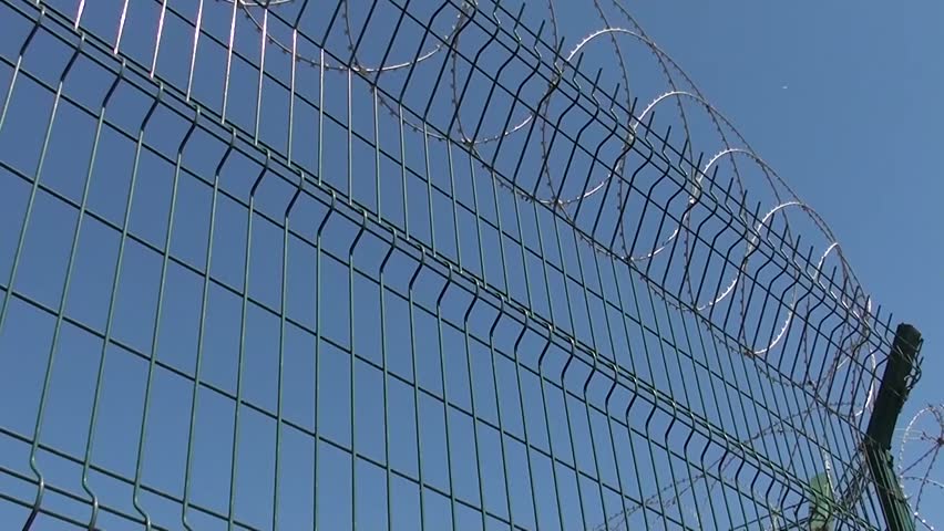 Metal Fence with Concertina Against Stock Footage Video (100% Royalty ...
