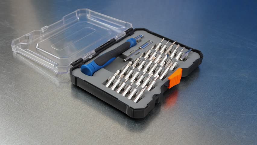 A set of tools with bits in a plastic case.