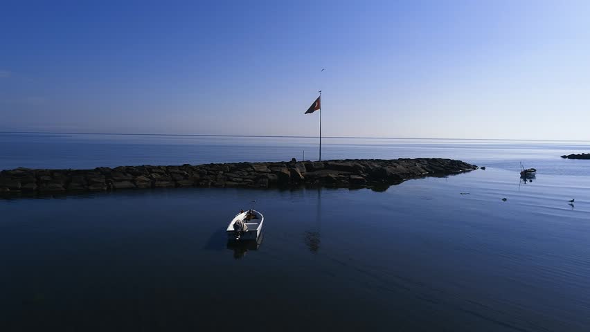 A Turkish flag and a boat on the beach