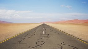 Pov of car stuck on cracked asphalt road stretching to horizon through arid and sandy landscape of Namib Desert in Namibia on hot african day - Powered by Shutterstock - Get 15% off with code: PIKWIZARD15