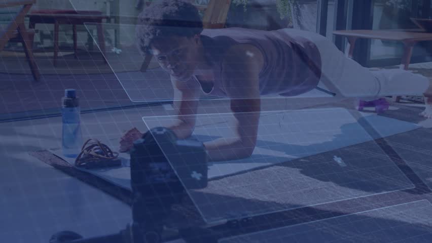 Man holding forearm plank on yoga mat while camera recording and overlays tracking fitness form. Home, exercise, core, focused, natural, light, tripod