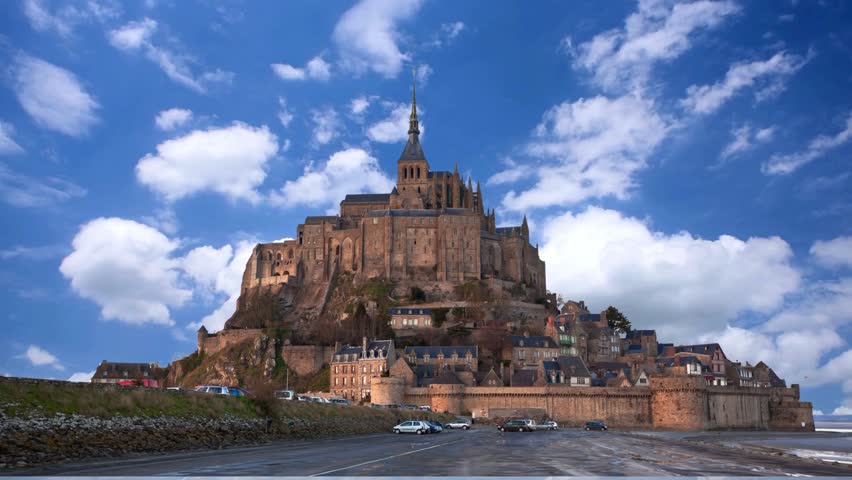 Mont Saint Michel, France  View of Mont Saint-Michel against skyMont Saint Michel abbey on the island during low tide, Normandy, Northern France, Europe. Tidal island with medieval gothic cathedral in Normandie. Travel and touristic destinationAerial view, France, Normandy, Salt marshes,  Mont-Saint-Michel monastery and abbey, Le Mont-Saint-Michel
