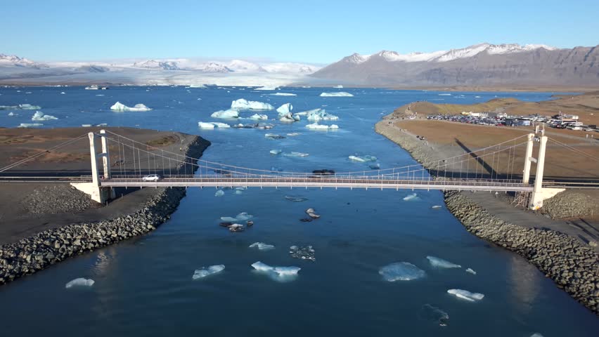 Aerial view of Jokulsarlon lagoon with drifting icebergs and clear blue water in Iceland