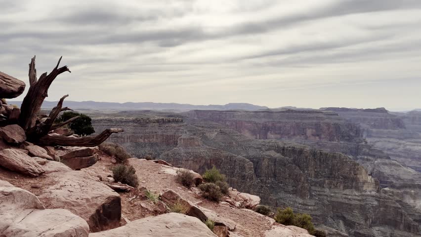 Scenic panoramic view of the Grand Canyon West Rim in Arizona, USA. Desert landscape with layered red rock cliffs, deep canyon formations, Colorado River view. A road trip near Eagle and Guano Point