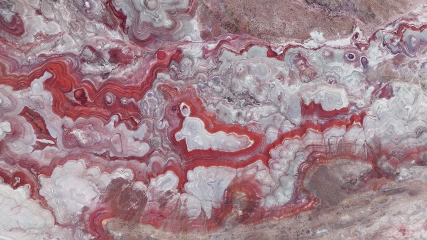 Aerial view of the intricate red and white swirling patterns of the bentonite hills in Hanksville, Utah, United States.