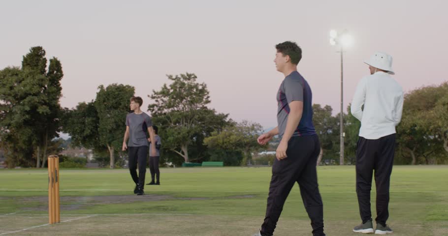 After non-striker exiting, Indian male bowler running on pitch to bowl ball at batsman, copy space. Sports, team, activity, outdoor, athletic, competition, recreation