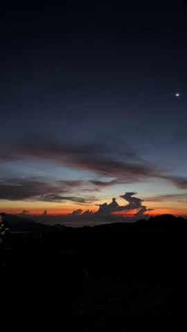 Cinematic sunset timelapse over Kelimutu volcanic crater lake. Dramatic time-lapse of changing twilight sky and moving clouds over the mystical crater in Flores East Nusa Tenggara Indonesia for nature documentary