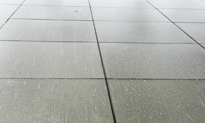 Wet tiled floor surface with water streaks and raindrops, minimal geometric pattern, urban pavement texture background, clean and simple backdrop