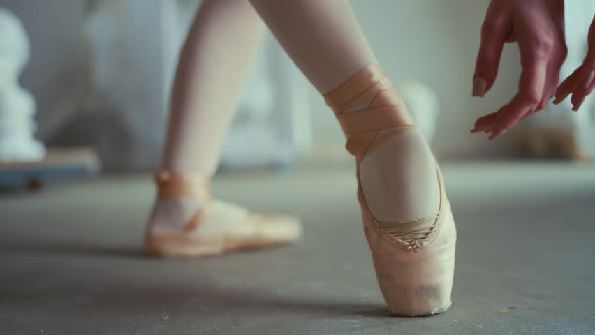 Ballet class in school of arts, closeup view of female feet in pointe shoes. Slow motion, talented ballerina rehearsing and performing classical choreography by amazing music, self-expression, hobby