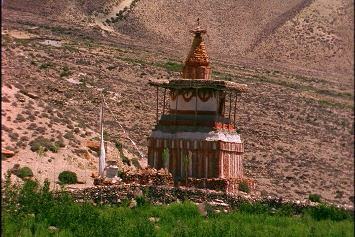 Brightly colored chorten on dry hill in Mustang, Nepal.