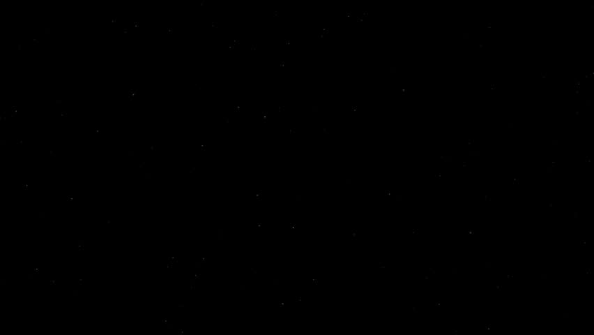 White shooting stars streak across a dark black night sky with subtle twinkling background stars