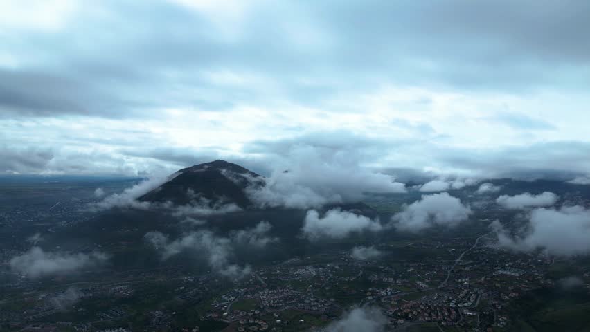Majestic Mountain Peak Emerging from Clouds