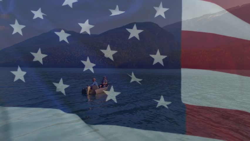 Two men operating outboard motor, moving boat left under rippling flag overlay for travel marketing. Lakeside, mountains, serene, companionship, watercraft, waterscape, goldenhour